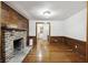 Bright living room boasts hardwood floors, wood paneling, and fireplace at 2206 Weepoolow Trl, Charleston, SC 29407