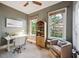 Well-lit office space with a ceiling fan, neutral walls, built in shelving and natural light at 2206 Weepoolow Trl, Charleston, SC 29407