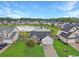 Aerial view of a single-Gathering home with a pond and landscaped yard in a residential neighborhood at 224 Market Hall St, Moncks Corner, SC 29461