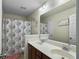 Bright bathroom featuring a double sink vanity, large mirror, and decorative shower curtain at 224 Market Hall St, Moncks Corner, SC 29461