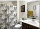 Well-lit bathroom featuring a floral shower curtain, dark wood vanity, and inspirational wall decor at 224 Market Hall St, Moncks Corner, SC 29461