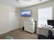 Spacious bedroom with a mounted TV, white dresser, work desk, closet and ceiling fan at 224 Market Hall St, Moncks Corner, SC 29461