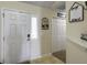 Bright entryway with a white front door, coat rack, decorative signs, and convenient closet space at 224 Market Hall St, Moncks Corner, SC 29461