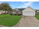 Well-maintained single-Gathering home with a manicured lawn, brick accents, and a two-car garage at 224 Market Hall St, Moncks Corner, SC 29461