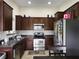 A well-equipped kitchen features stainless steel appliances, dark cabinetry, and ample counter space at 224 Market Hall St, Moncks Corner, SC 29461