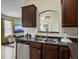 A kitchen with dark cabinetry and stainless appliances open to a view of the living room at 224 Market Hall St, Moncks Corner, SC 29461