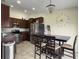 This kitchen boasts stainless steel appliances, dark cabinets, and a charming chandelier over the eat-in table at 224 Market Hall St, Moncks Corner, SC 29461
