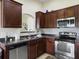 A kitchen showcases stainless steel appliances, dark cabinetry, and ample counter space for meal preparation at 224 Market Hall St, Moncks Corner, SC 29461
