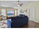 Comfortable living room featuring a large TV, ceiling fan, and cozy blue sofa at 224 Market Hall St, Moncks Corner, SC 29461