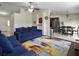 Open-concept living room with blue sofas and a view to the kitchen featuring stainless steel appliances at 224 Market Hall St, Moncks Corner, SC 29461