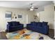 The living room features plush blue sofas, a ceiling fan, and natural light, creating a welcoming space at 224 Market Hall St, Moncks Corner, SC 29461
