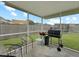 Relaxing screened-in patio with chairs and a grill, perfect for outdoor dining and entertaining at 224 Market Hall St, Moncks Corner, SC 29461