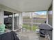 Cozy screened-in patio with a grill and seating area, offering a great space for relaxation and leisure at 224 Market Hall St, Moncks Corner, SC 29461