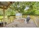 Backyard deck features a grill, patio furniture, and a view of the trees and shed at 2343 Herndon Dr, Charleston, SC 29414