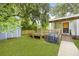 Backyard features a wooden deck, an outdoor grill, green grass, and a shed for extra storage at 2343 Herndon Dr, Charleston, SC 29414