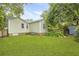 Backyard with grassy lawn, partial deck, and a shed features lush greenery, enhancing outdoor appeal at 2343 Herndon Dr, Charleston, SC 29414