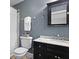 Bathroom boasts a marble top vanity with black cabinets, a black medicine cabinet, and a shower with a white curtain at 2343 Herndon Dr, Charleston, SC 29414