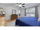 Bedroom features a ceiling fan, wood floors, a large window, and a dresser with a mirror at 2343 Herndon Dr, Charleston, SC 29414