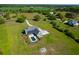 Aerial perspective of a home with backyard pool, firepit and spacious, green lawn at 2621 Anchor Watch Dr, Wadmalaw Island, SC 29487