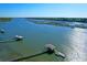 Picturesque aerial view of waterfront homes, private docks and lush marshland at 2621 Anchor Watch Dr, Wadmalaw Island, SC 29487