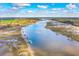An aerial view of an expansive river with multiple docks and gorgeous landscapes, a boater's paradise at 2621 Anchor Watch Dr, Wadmalaw Island, SC 29487