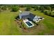 Aerial view of home with a private backyard pool, outdoor living space and spacious lot at 2621 Anchor Watch Dr, Wadmalaw Island, SC 29487