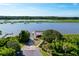 Scenic aerial view of waterway featuring docks, lush greenery, and a paved driveway leading to the property at 2621 Anchor Watch Dr, Wadmalaw Island, SC 29487