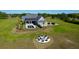 Aerial view of backyard with fire pit, seating area, pool and outdoor living space at 2621 Anchor Watch Dr, Wadmalaw Island, SC 29487