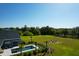 Aerial view showcases the pool, palm trees, firepit with chairs, and manicured backyard landscaping at 2621 Anchor Watch Dr, Wadmalaw Island, SC 29487
