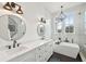 Bright bathroom boasts dual sinks, marble countertops, large windows for natural light and a soaking tub at 2621 Anchor Watch Dr, Wadmalaw Island, SC 29487