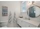 A coastal-themed bathroom featuring a vanity, decorative mirror, and nautical accents creating a charming space at 2621 Anchor Watch Dr, Wadmalaw Island, SC 29487