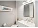 Powder room featuring shiplap accent wall, framed art, white vanity, and modern fixtures at 2621 Anchor Watch Dr, Wadmalaw Island, SC 29487