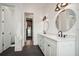 A pristine bathroom with a double vanity, sleek fixtures, and an arched doorway for a clean look at 2621 Anchor Watch Dr, Wadmalaw Island, SC 29487
