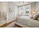 Bright bedroom with an inviting bed, stylish decor, and ample natural light from a large window at 2621 Anchor Watch Dr, Wadmalaw Island, SC 29487