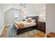 Bedroom showcases a plush bed, wooden floors, a patterned blue rug and plentiful natural light at 2621 Anchor Watch Dr, Wadmalaw Island, SC 29487