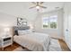Bright bedroom featuring a patterned duvet cover, ceiling fan, and natural light through a double window at 2621 Anchor Watch Dr, Wadmalaw Island, SC 29487