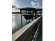 Covered boat dock with boat lift and serene waterfront views. Great for boating enthusiasts at 2621 Anchor Watch Dr, Wadmalaw Island, SC 29487