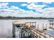 Modern boat lift with dual kayaks and a motorboat, offering direct access to the waterway at 2621 Anchor Watch Dr, Wadmalaw Island, SC 29487