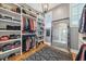 A spacious walk-in closet with organized shelving, a large mirror, and a patterned rug over wood floors at 2621 Anchor Watch Dr, Wadmalaw Island, SC 29487