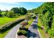 Anchorage Plantation entrance with beautifully maintained landscaping, blooming trees and winding road at 2621 Anchor Watch Dr, Wadmalaw Island, SC 29487