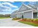 Charming exterior of home, featuring gray siding, manicured lawn, and a driveway leading to the garage at 2621 Anchor Watch Dr, Wadmalaw Island, SC 29487