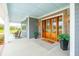 Inviting front porch with double doors, beautiful brickwork, and rocking chairs at 2621 Anchor Watch Dr, Wadmalaw Island, SC 29487