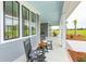 Charming front porch with rocking chairs, a stylish ceiling, and ample seating at 2621 Anchor Watch Dr, Wadmalaw Island, SC 29487