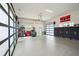 Spacious garage with frosted glass doors, epoxy flooring, and ample storage cabinets at 2621 Anchor Watch Dr, Wadmalaw Island, SC 29487