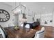 Open kitchen with a large island, pendant lighting, and stainless appliances overlooking dining area at 2621 Anchor Watch Dr, Wadmalaw Island, SC 29487
