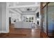 Open-concept living space with hardwood floors, a fireplace, and seamless transition to kitchen at 2621 Anchor Watch Dr, Wadmalaw Island, SC 29487