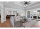Elegant living room with hardwood floors, a ceiling fan, and an open floor plan to the kitchen at 2621 Anchor Watch Dr, Wadmalaw Island, SC 29487