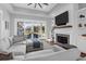Cozy living room with fireplace, TV, and sliding doors for a light-filled space at 2621 Anchor Watch Dr, Wadmalaw Island, SC 29487