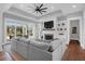 Bright, open living room featuring a fireplace, built-ins, and sliding glass doors to the patio at 2621 Anchor Watch Dr, Wadmalaw Island, SC 29487