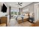 Comfortable main bedroom boasts hardwood floors, patio access, ceiling fan, and en-suite bath at 2621 Anchor Watch Dr, Wadmalaw Island, SC 29487